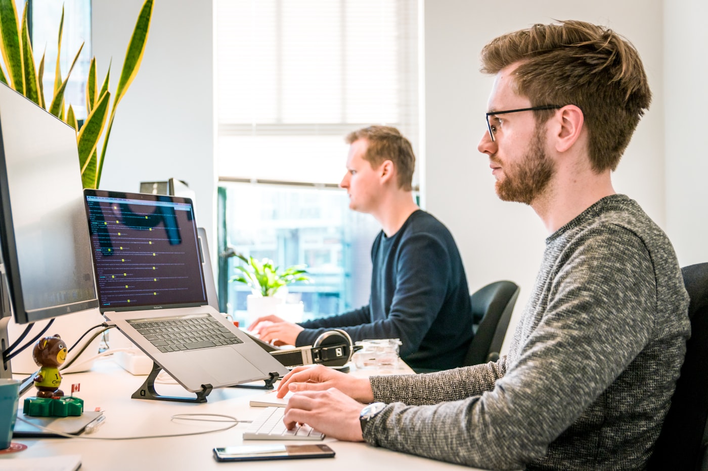 Developers reviewing code and plans during a delivery meeting